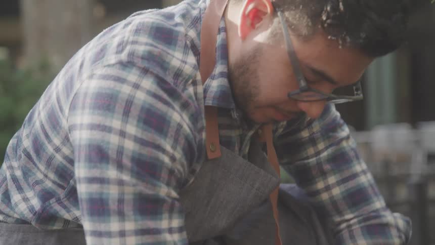 Man in glasses and apron outdoors