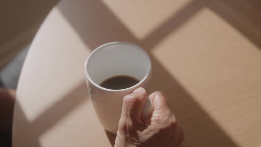 A man is holding a cup of coffee