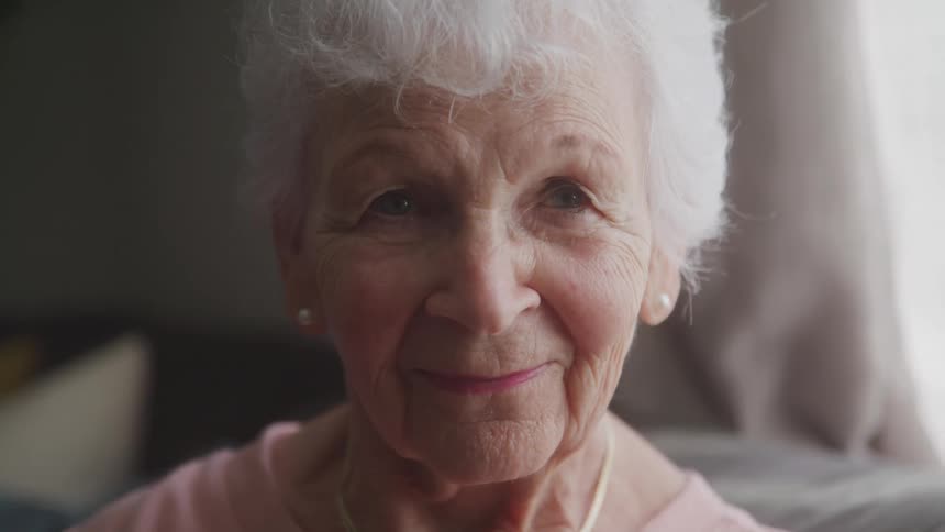 Elderly lady with happy expression in an indoor space