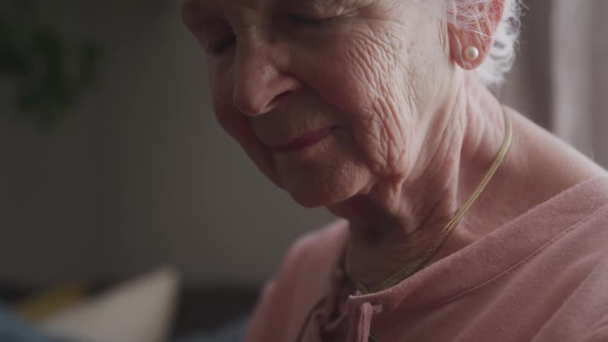 Portrait of an elderly woman with her eyes closed