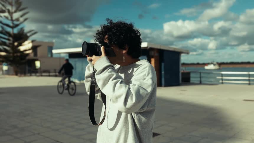 A person is taking photos with a large camera