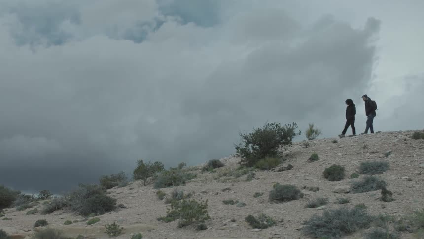 A person walking on a dirt hill