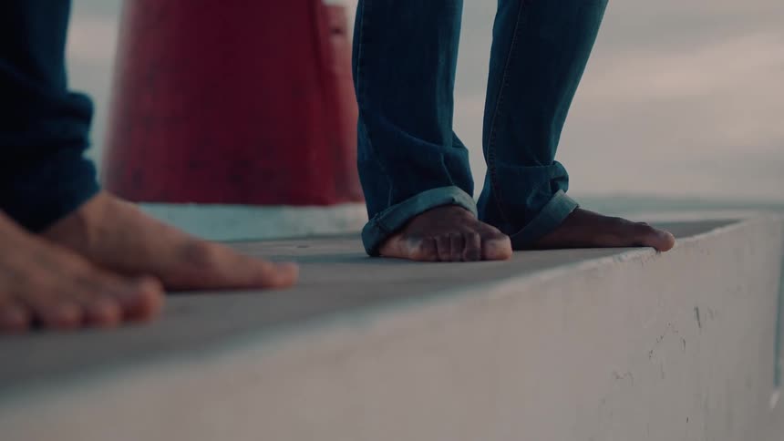 Bare feet of two men dancing