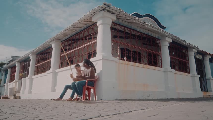 Two men play music and have fun outside