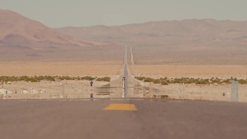A man is running in the distance past the desert