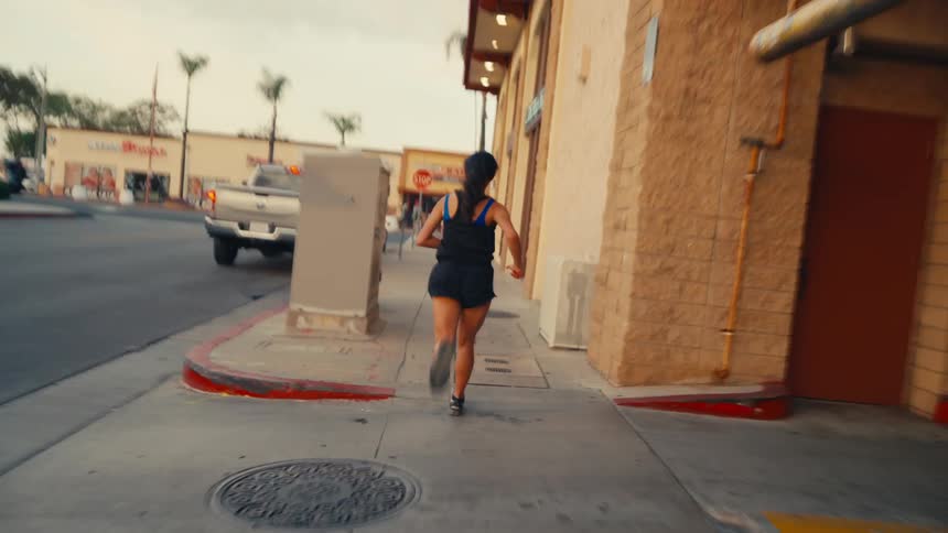 Man running and handing the baton to a woman who runs away at high speed