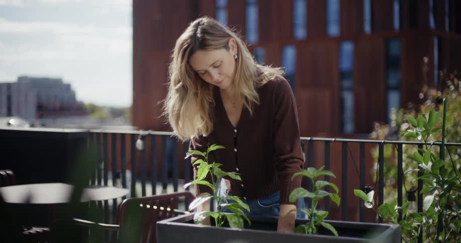Woman planting in a black pot