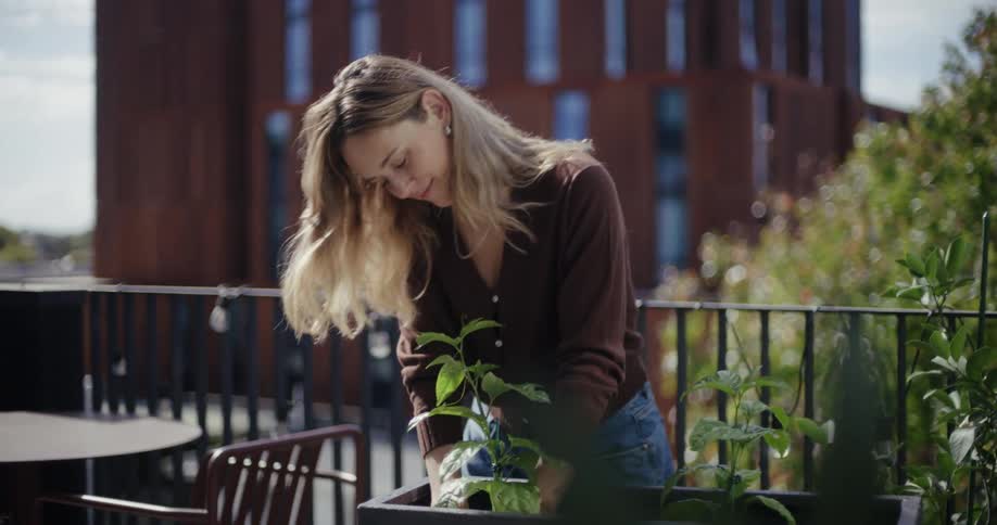 The woman is planting in the garden