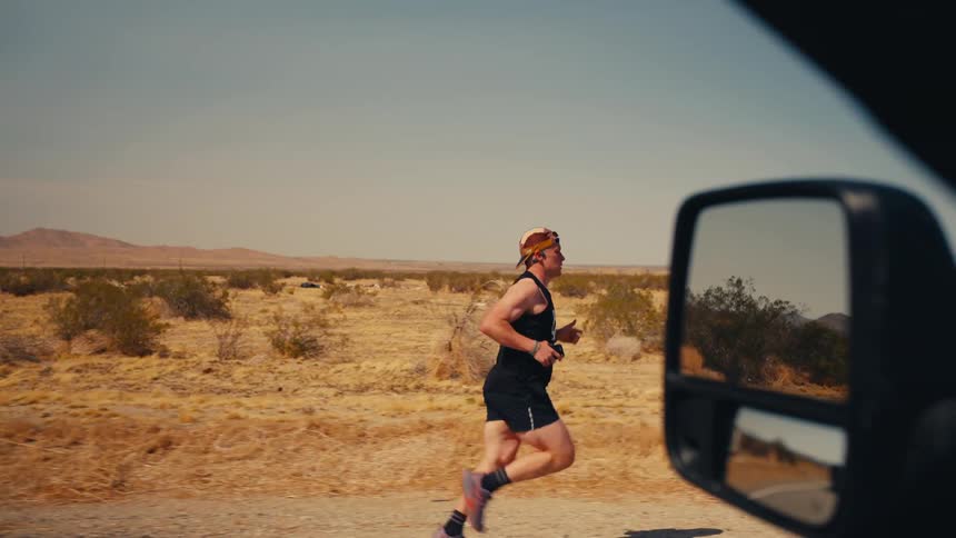 The man can be seen running past the desert from the car