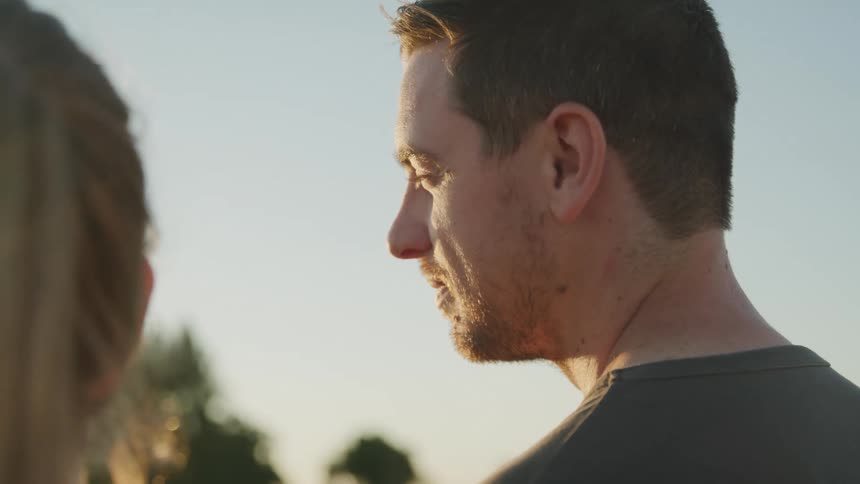 A man looks over to a woman