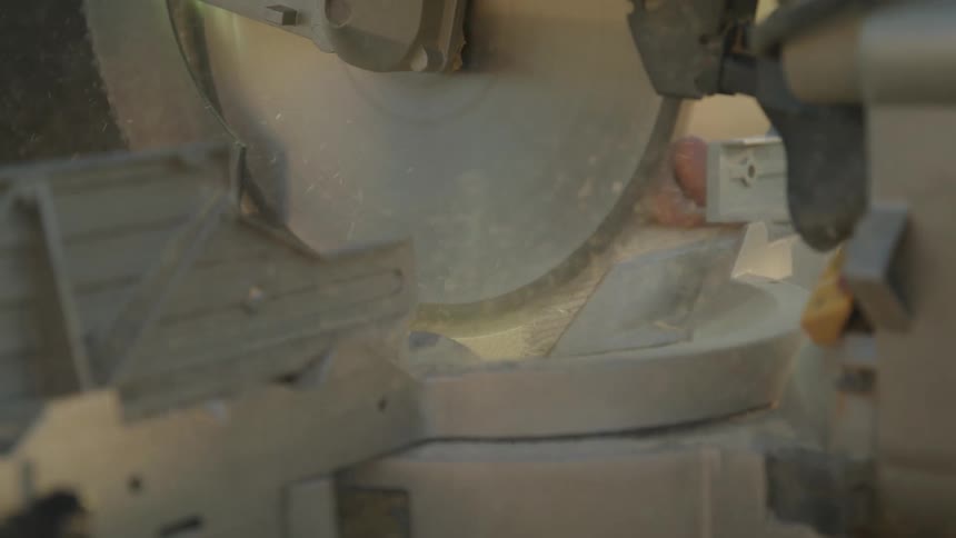 The saw gives off sawdust as it cuts
