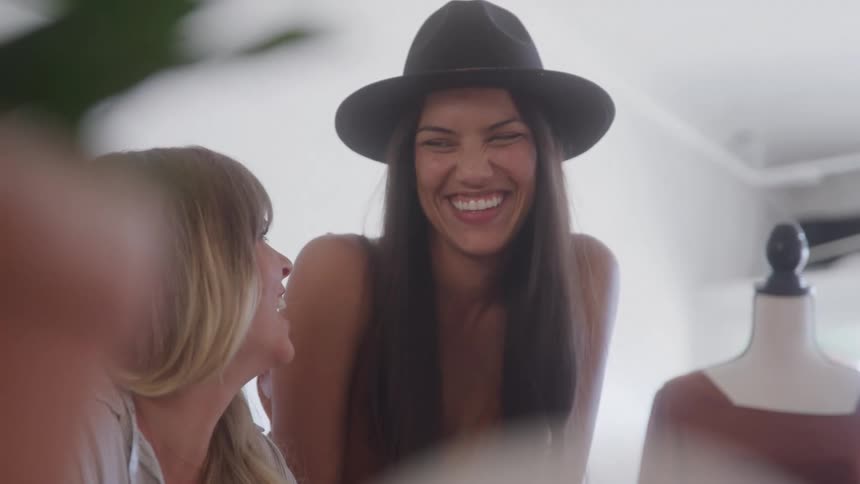 Two women laughing and talking