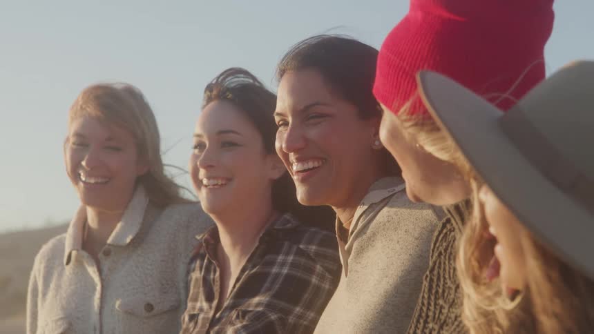 5 women close together smiling and having fun