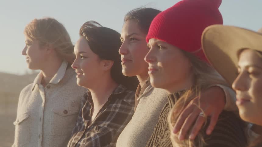 Portrait of women hugging together outdoors
