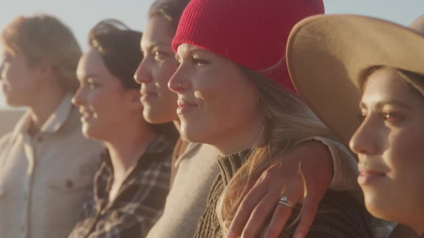 A group of women stands outside together
