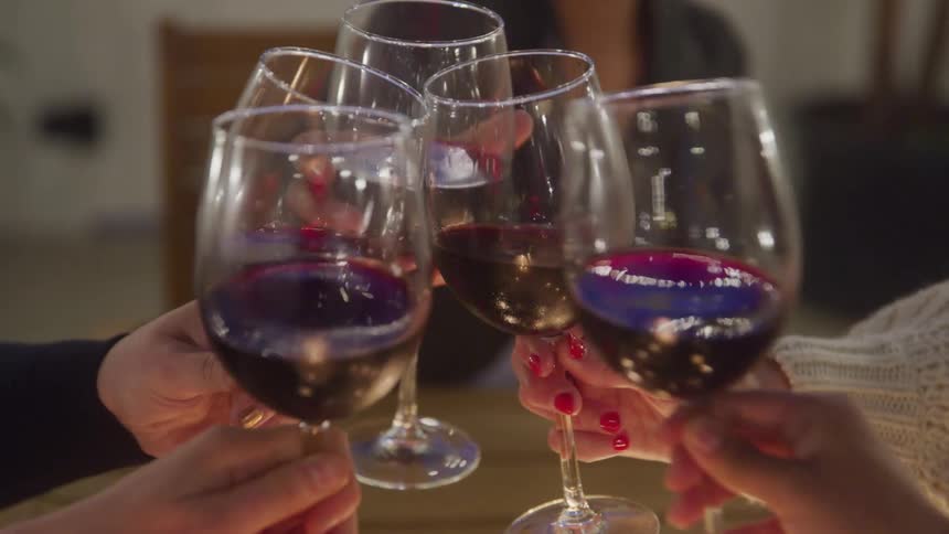 People toasting glasses of red wine