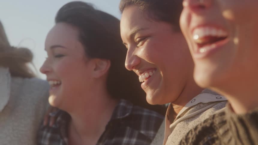 Women laugh on a sunny day
