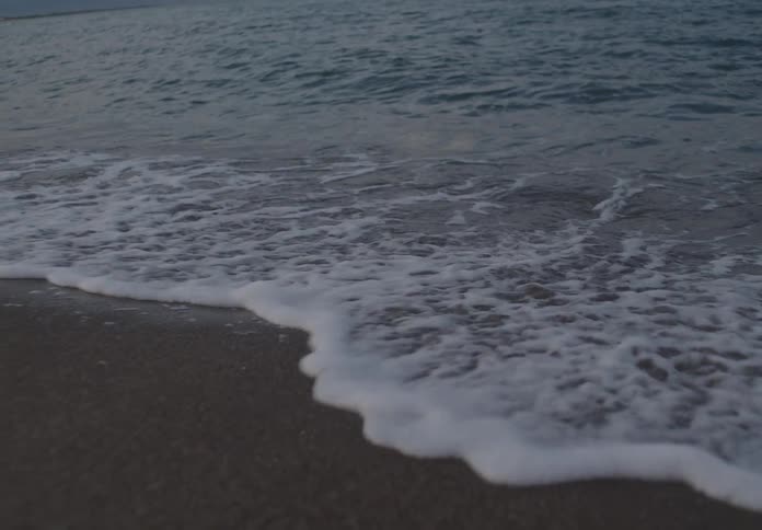 The tide moves over the sand