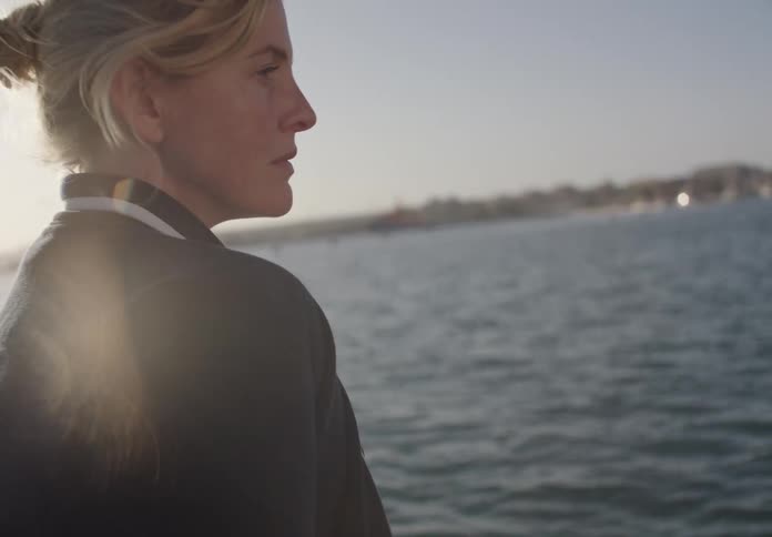 A woman looks out over the water