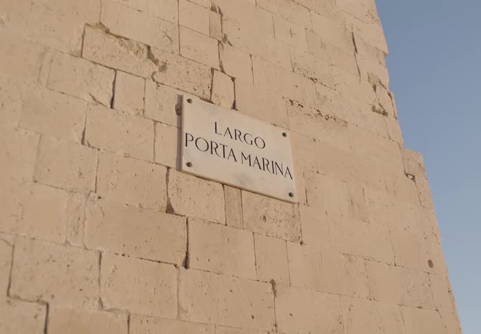 Signage of largo porta marin bolted on a neutral colored brick wall