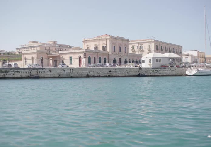 Coastal view of historic buildings by a calm marina