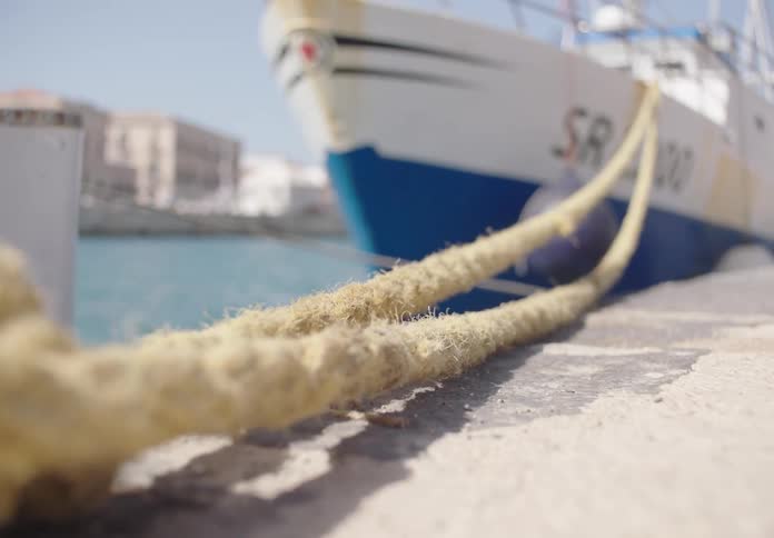 Close up of dock lines attached to a ship at the ship dock during daytime