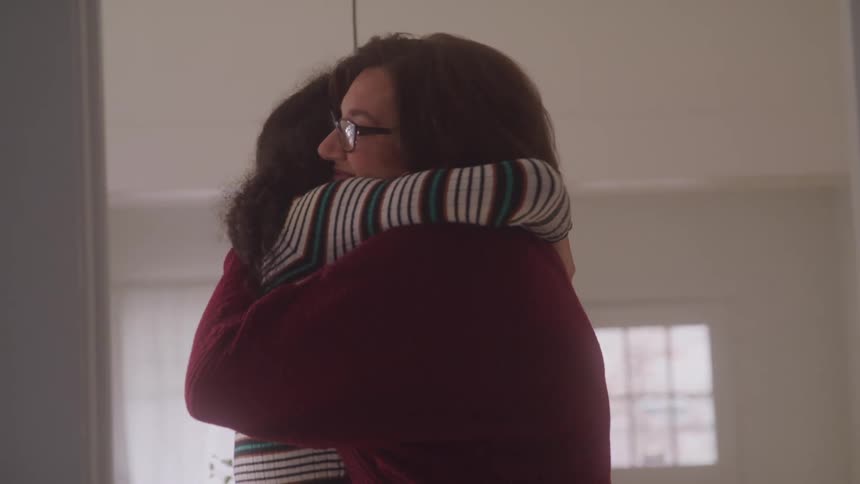 Two women in a loving moment hugging each other