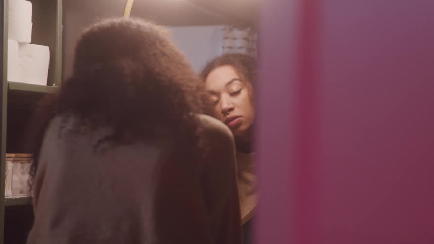 Woman looking at herself in the mirror