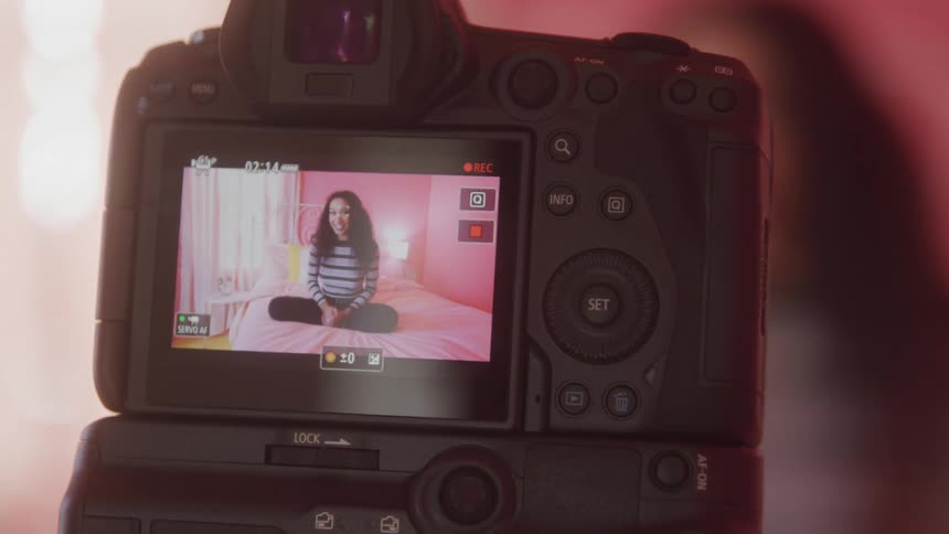 A woman films a video of herself