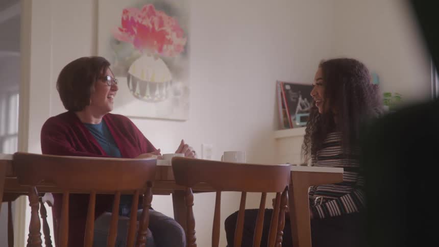 Women talk and laugh together