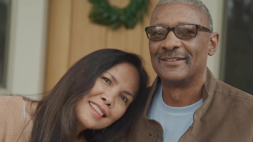 A man and woman smile together