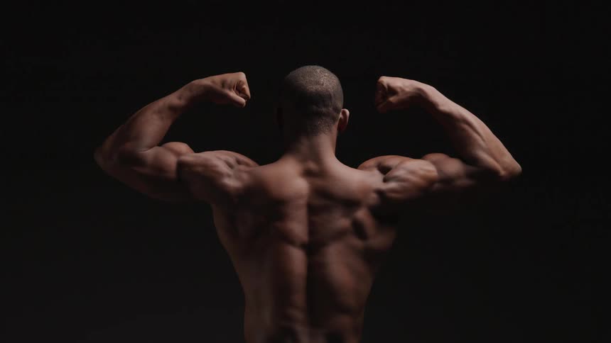 A muscular person is shown from behind flexing both arms against a dark background