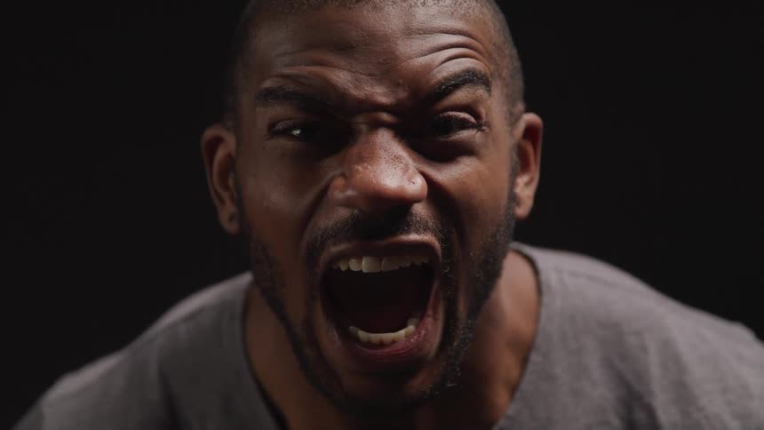 Black man letting out a loud angry primal scream