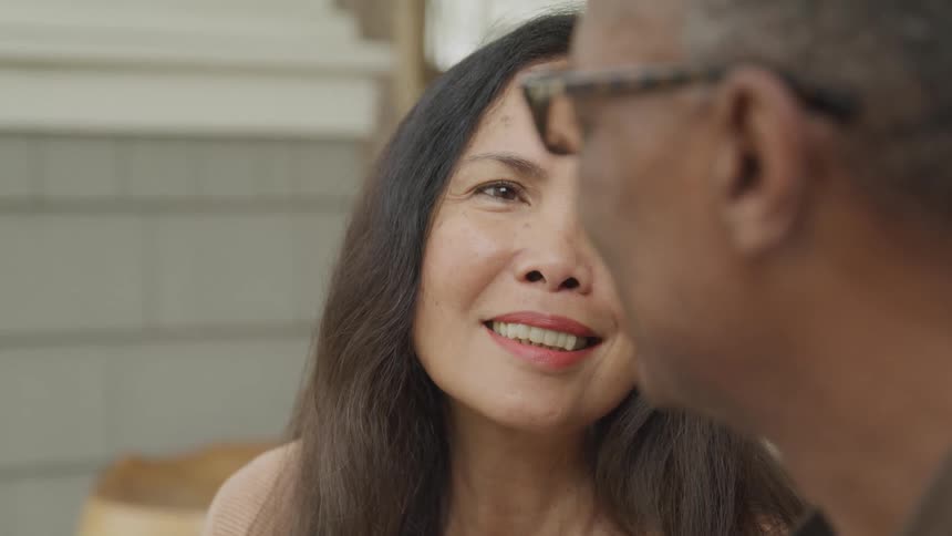 Smiling woman with happy expression looking at man beside her