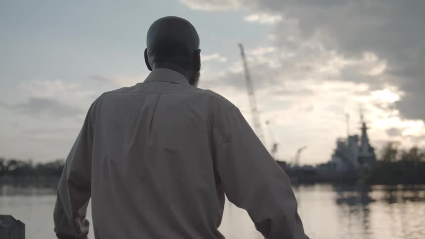 A man looks out over the water
