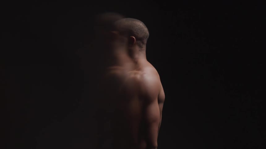 Multiple exposures of a shirtless man against a black background