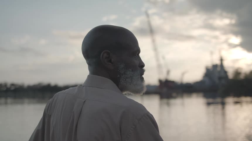 A man looks out over the water