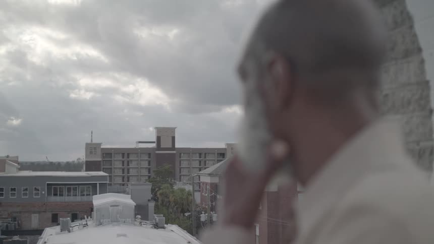 White bearded man watching the city