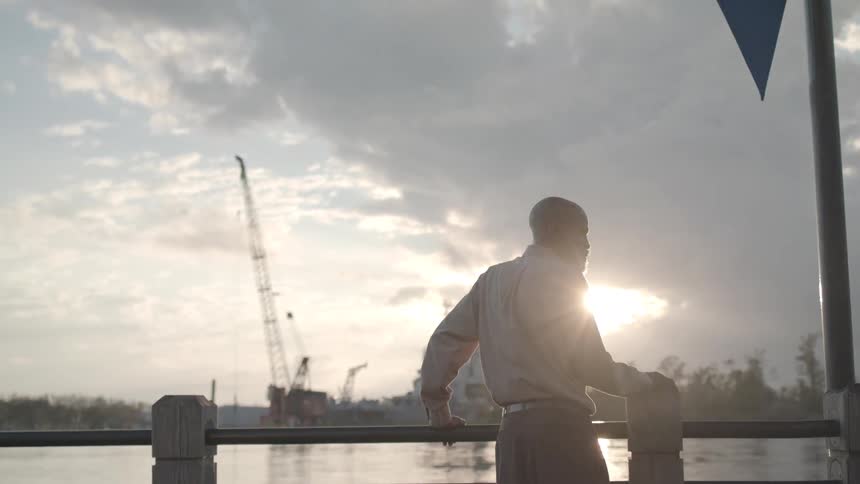 A man looks out over the water
