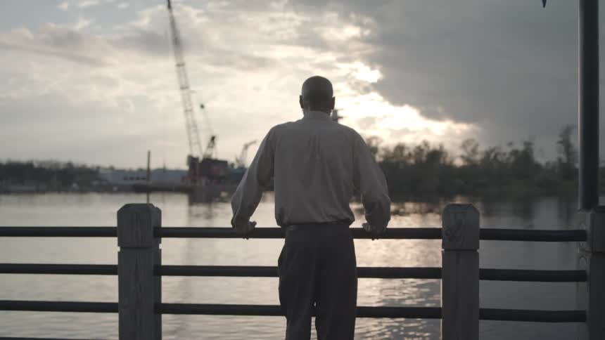 A man looks over the water