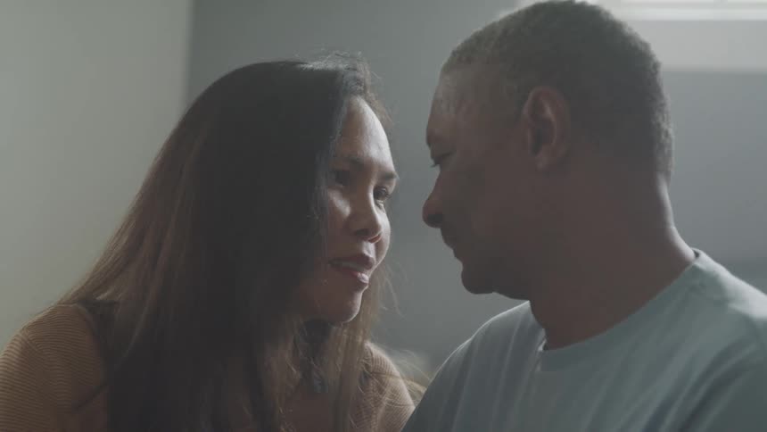 Couple leaning their foreheads against each other
