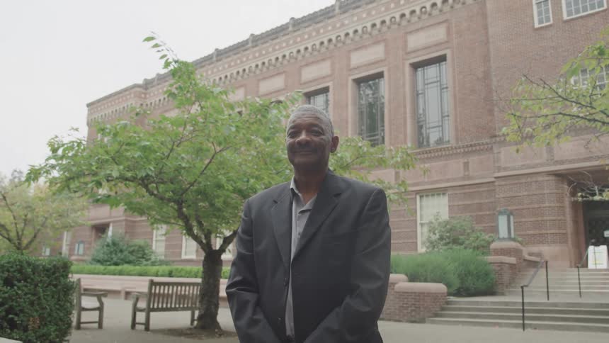 A man smiles at the camera