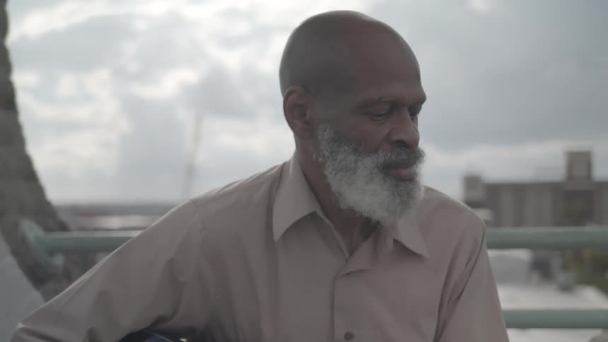Man sitting outdoors and shaking his head