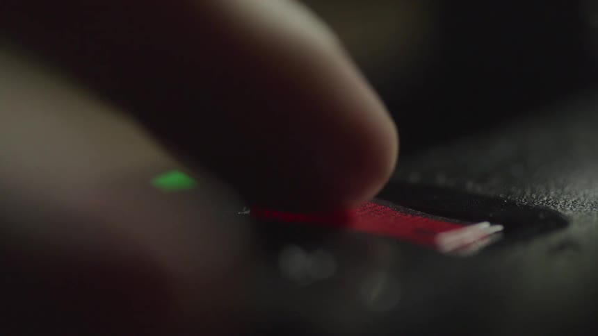 A person flicks a switch turning the light off