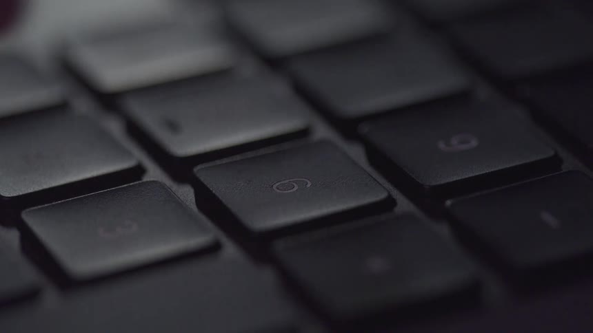 A person is typing fast on a computer keyboard
