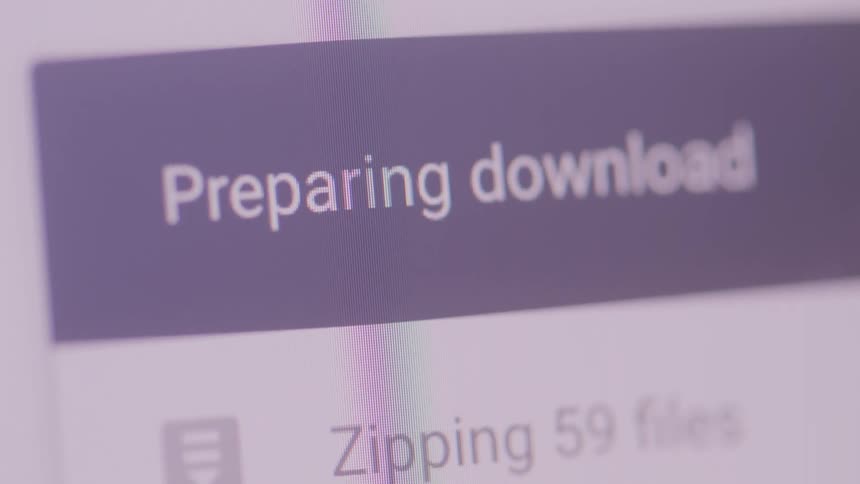 A close view of a digital screen displays text indicating preparing download and zipping 59 files