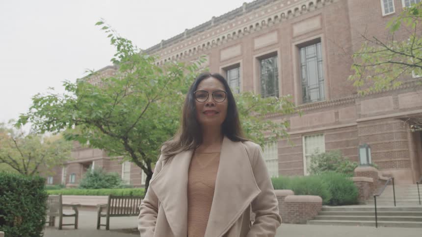 Happy woman outdoors with a building in the background
