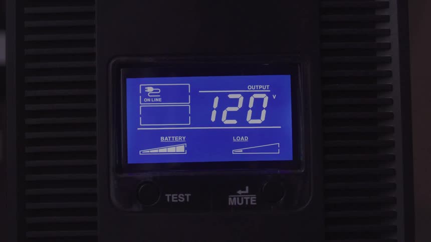 Digital meter displays 120 v output alongside battery and load level bars flanked by test and mute buttons