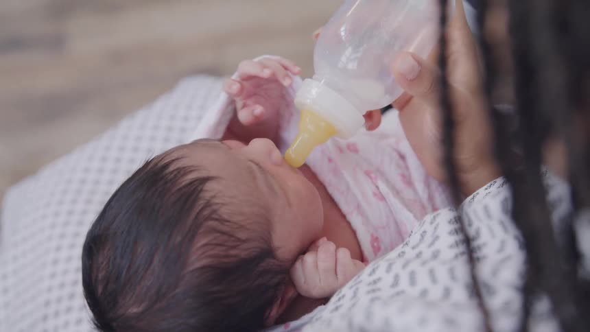 Mother giving a bottle to a baby