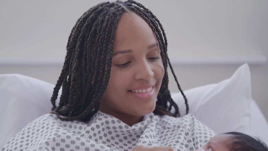 Smiling woman holding her baby son